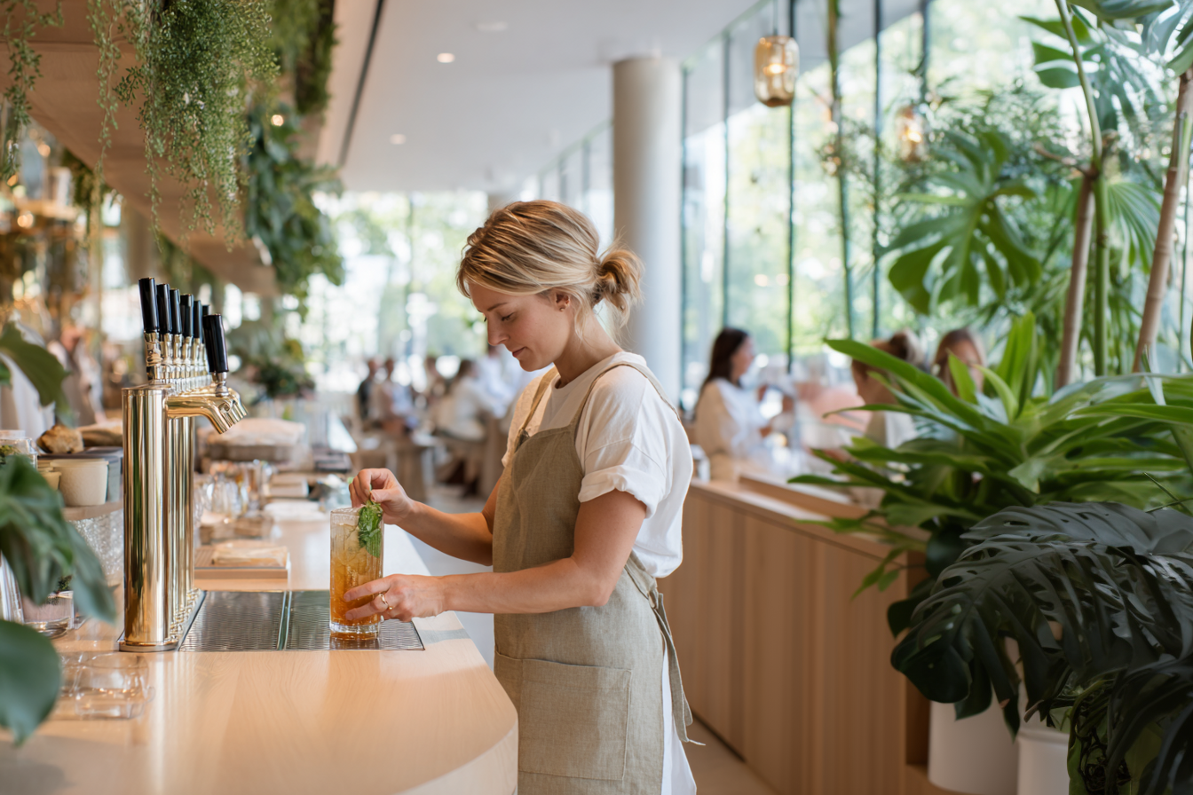 Sparkling tea being poured from tap in a bright cafe