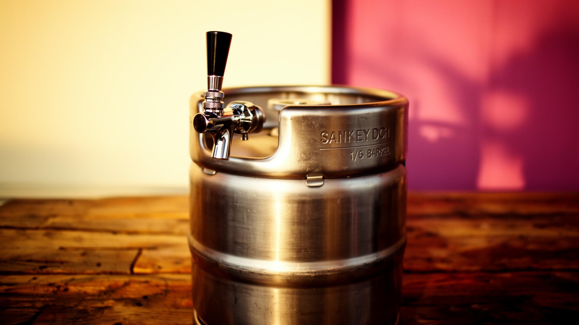 Stainless steel 1/6 barrel non-alcoholic keg with Sankey D coupler on a warm wooden bar